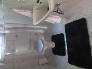 a bathroom with a toilet and two towels at Ferienhaus Tschenett in Imst