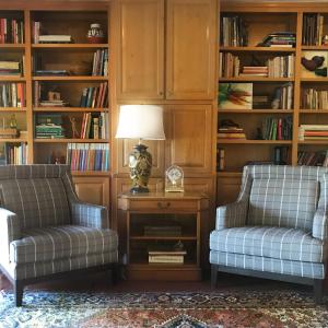 two chairs and a lamp in a room with book shelves at Morning Star Bed & Breakfast of Corrales in Corrales +27 photos