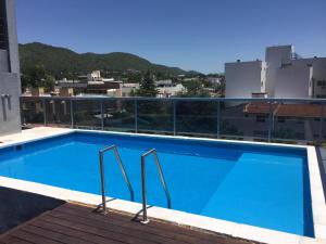 a swimming pool on the roof of a building at Dpto Villa Carlos Paz - cochera auto chico in Villa Carlos Paz
