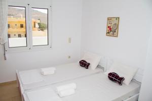 A bed or beds in a room at white house by the sea