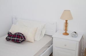 A bed or beds in a room at white house by the sea
