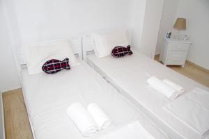 A bed or beds in a room at white house by the sea