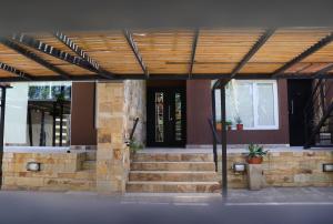 a building with stairs and a wooden roof at Limay Bed&Breakfast in Neuquén
