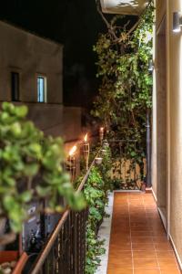 a hallway with plants and a fence at night at TaoMau - Duomo Square in Taormina
