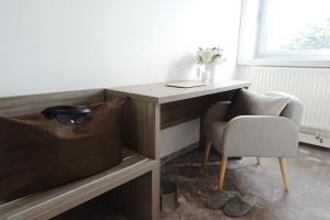 a desk and a chair in a room at Hotel La Chaumette in Privas