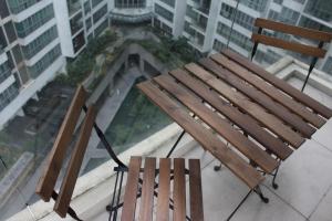 two wooden benches sitting on top of a building at ✦Time & Traveller✦Regalia Suites and Residence✦KLCC view Infinity Pool✦双子塔无边泳池 in Kuala Lumpur