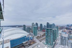 a view of a city with tall buildings and a stadium at Chol Furnished Suites 2 Bedrooms Downtown Toronto Million Dollar CN Tower View MTCC Rogers Centre Blue Jays TIFF Free Parking in Toronto