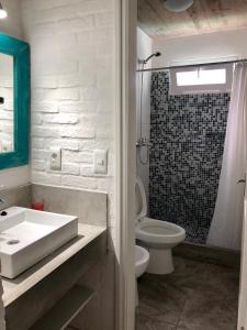 a white bathroom with a sink and a toilet at Las Olas Aparts in La Paloma