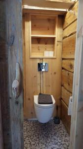 a bathroom with a toilet in a wooden cabin at Tiny house with Fjordview! in Lauvstad