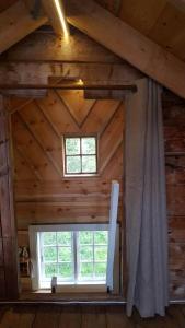 a room with a window in a log cabin at Tiny house with Fjordview! in Lauvstad
