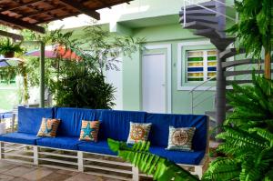 a blue couch on a patio with plants at Casa da Adriana Pousada in Fortaleza