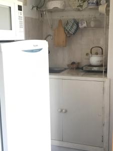 a kitchen with a white refrigerator and a microwave at Golf Tower in Atlántida