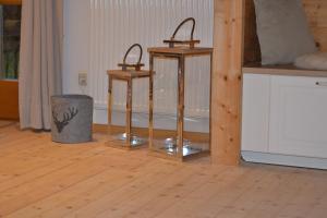 two candles in a room with a wooden floor at Chalet Königsstand in Garmisch-Partenkirchen