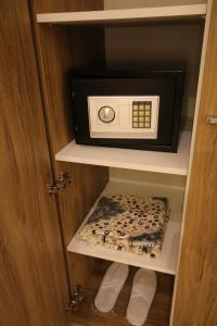 a microwave oven sitting inside of a cabinet at Assilah Hotel in Al Madinah