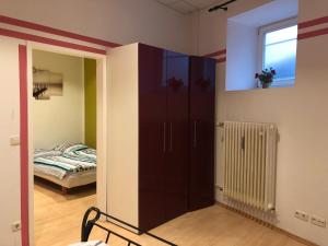 a room with a large cabinet and a bed at Munich Apartment Harras (Souterrain) in Munich