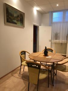 a wooden table and chairs in a room at Munich Apartment Harras (Souterrain) in Munich