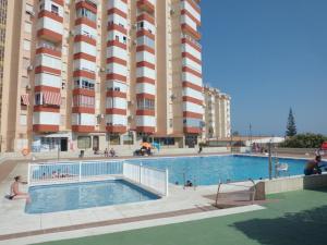 a swimming pool in front of a large building at Apartamento Peñalver 813 in Torrox Costa
