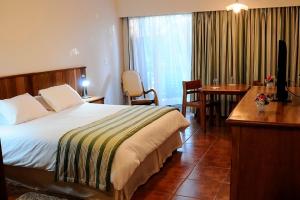 Ένα ή περισσότερα κρεβάτια σε δωμάτιο στο Hotel Passarim