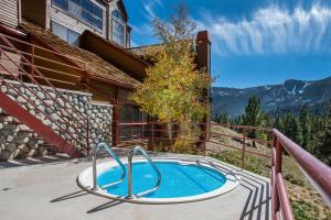 a hot tub on the balcony of a house at Aspen Creek by 101 Great Escapes in Mammoth Lakes