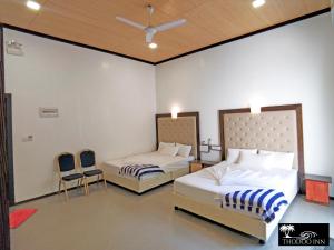 Ένα ή περισσότερα κρεβάτια σε δωμάτιο στο Thoddoo Inn