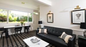 a living room with a couch and a table at Battery Point Boutique Accommodation in Hobart