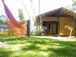 a small house with a hammock in the yard at Bahia Soul - Flow Beach House - Taipu de Fora - Península de Maraú in Barra Grande +156 photos