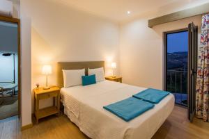 een slaapkamer met een groot bed en een balkon bij Feel Discovery Douro LAS House in Peso da Régua +45 foto's
