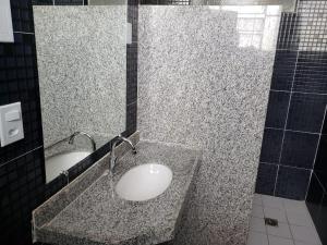 a bathroom with a sink and a mirror at Excelsior Hotel in Caxias das Aldeias Altas