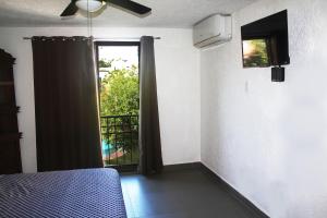 a bedroom with a bed and a window with a view at Casa Wilo in Cancún