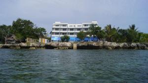 a building on the shore of a body of water at Panglao Sea Resort - Tangnan in Panglao Island