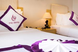 Postel nebo postele na pokoji v ubytování TTC Hotel - Ngoc Lan