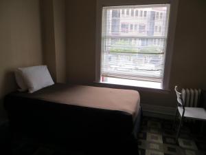 a small bedroom with a bed and a window at Hotel North Beach in San Francisco