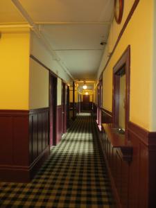 an empty hallway in an old building with a checkered floor at Hotel North Beach in San Francisco