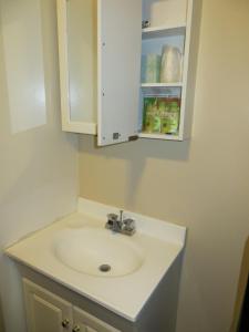 a white sink sitting under a mirror in a bathroom at Hotel North Beach in San Francisco