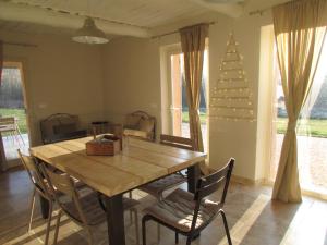 a dining room with a table and chairs and a christmas tree at le bastidon in Villars