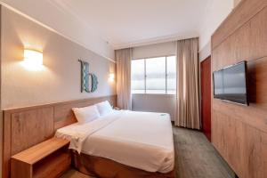 Tempat tidur dalam kamar di Hotel Bencoolen Singapore