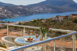 a table with two glasses of wine on a balcony at Dahlia Penthouse - Beautiful Luxurious Private Pool Fantastic Harbour Views in Kalkan