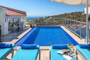 a swimming pool with a view of the ocean at Dahlia Penthouse - Beautiful Luxurious Private Pool Fantastic Harbour Views in Kalkan