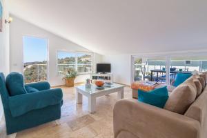 een woonkamer met een bank, stoelen en een tafel bij Dahlia Penthouse - Beautiful Luxurious Private Pool Fantastic Harbour Views in Kalkan