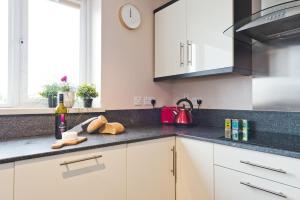 a kitchen with a sink and a counter top at Broc House Suites in Dublin