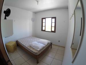 En eller flere senge i et værelse på Residencial Sol de Ibiraquera