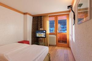 TV a/nebo společenská místnost v ubytování Style Hotel Grifone