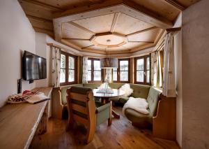 a living room with a couch and a table at Auenhütte in Hirschegg