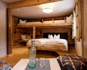 a room with two bunk beds and a bottle on a table at Auenhütte in Hirschegg