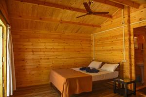 a bedroom with a bed in a wooden cabin at Agonda Paradise in Agonda
