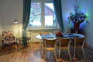 a dining room with a table and a christmas tree at Willa Skalite in Szczyrk