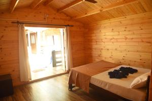 a bedroom with a bed and a large window at Agonda Paradise in Agonda