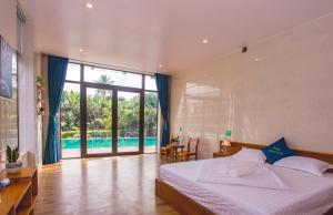 a bedroom with a bed and a swimming pool at Hugo Homestay in Phong Nha +67 photos