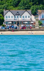 a large building on the beach with the water at Waterfront Inn in Shanklin