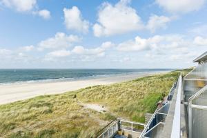 a beach with a view of the ocean at WestCord Strandhotel Seeduyn in Oost-Vlieland
